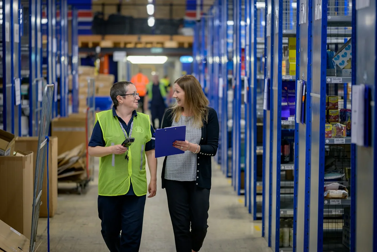 A friendly logistics team checking orders at work in the warehouse