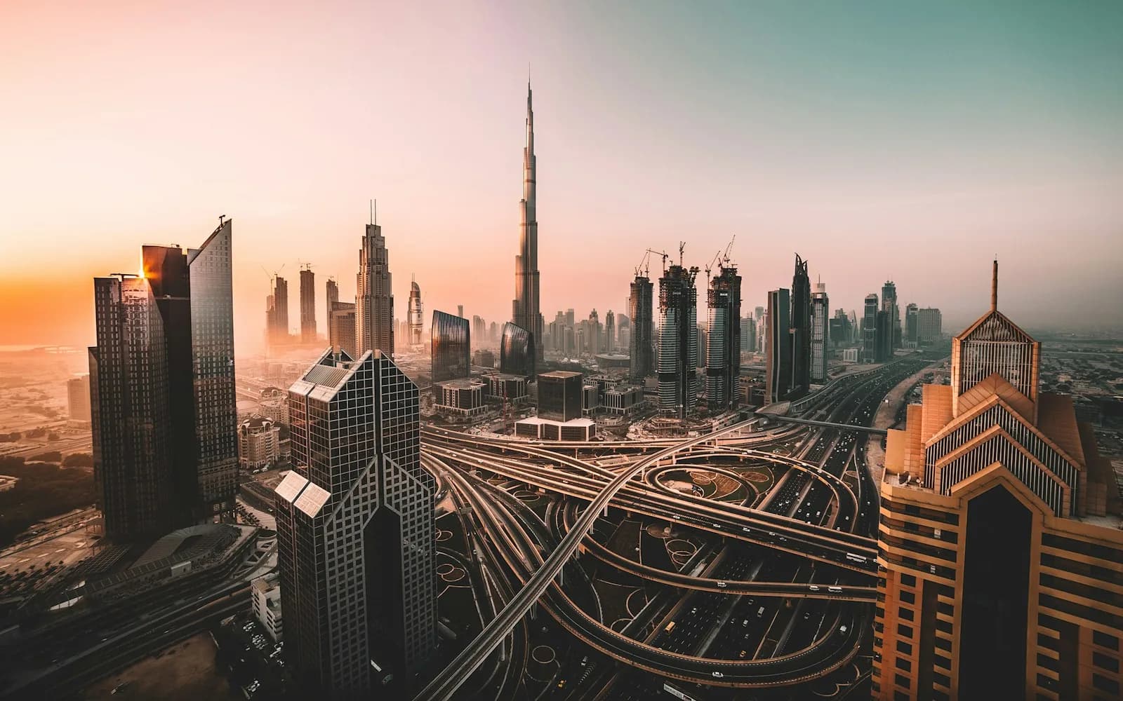 The Burj Khalifa rising above the Dubai skyline and highway interchange